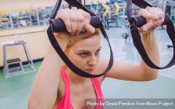 Close up of woman using equipment in gym 5nAZQ0