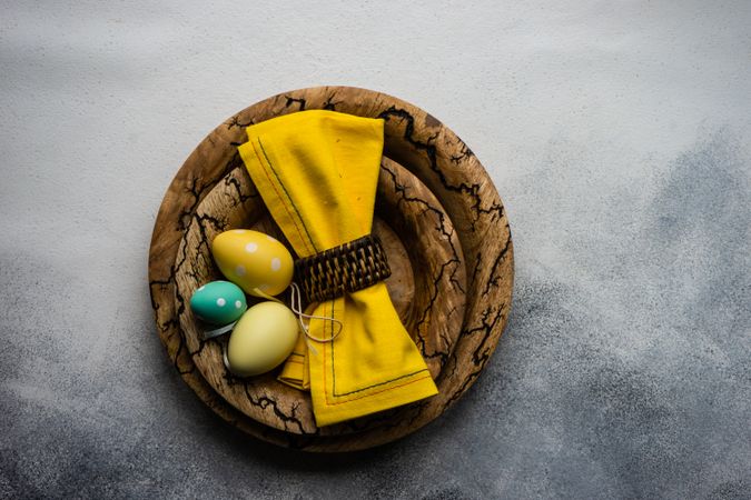 Easter table setting with rustic plates and yellow napkin