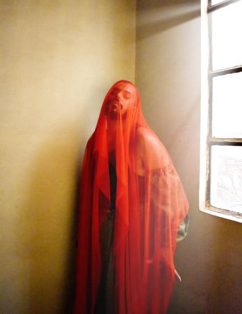 Man wearing red textile standing indoor