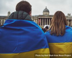London, England, United Kingdom - March 5 2022: Man and woman draped in Ukrainian flag at protest 5lnvvb