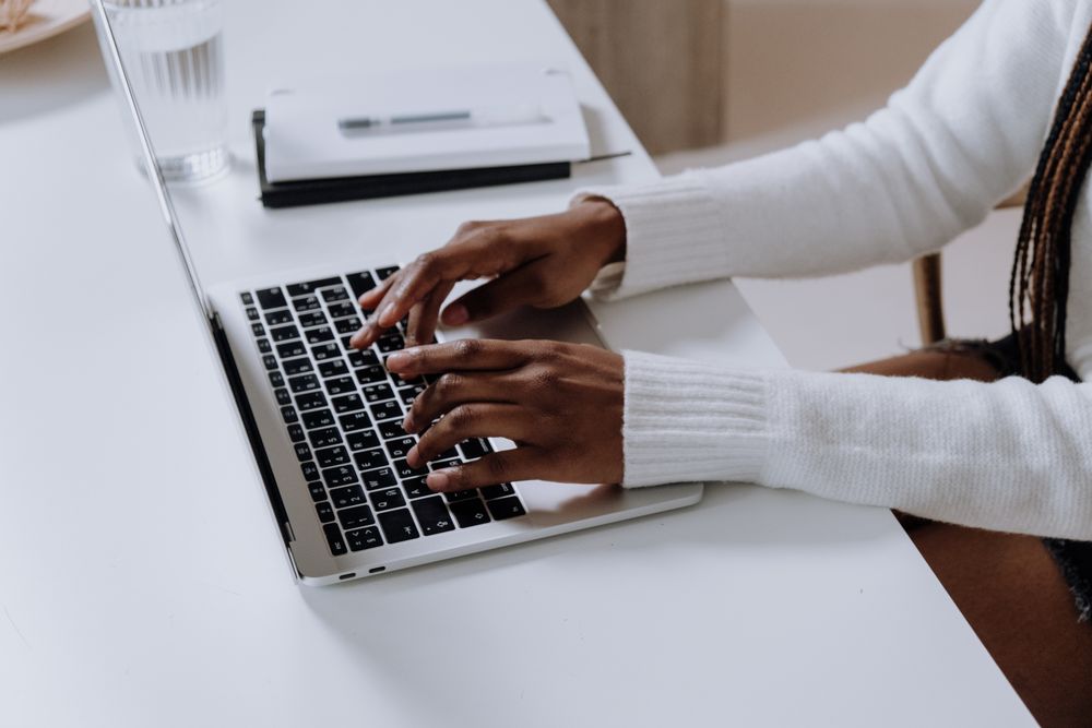 Cropped image of Black woman using laptop