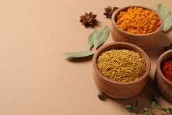 Bowls of cumin and turmeric with copy space