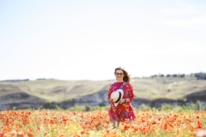 Excited woman laughing in field