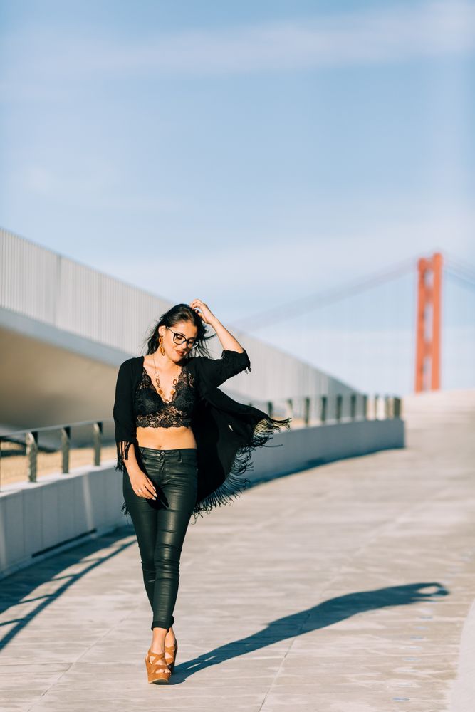 Trendy female standing on urban background