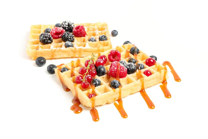 Waffles under caramel topping isolated on blank background