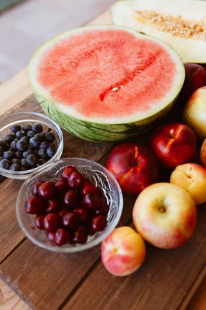 Delicious summer fruits on wooden table