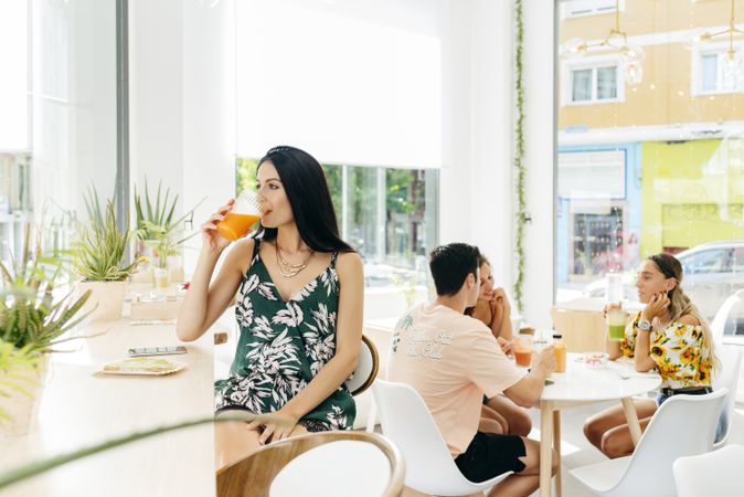 Woman with healthy drink sitting in cafe