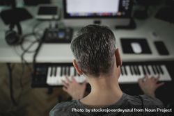 Music producer working on a project at his home studio 47mmGk