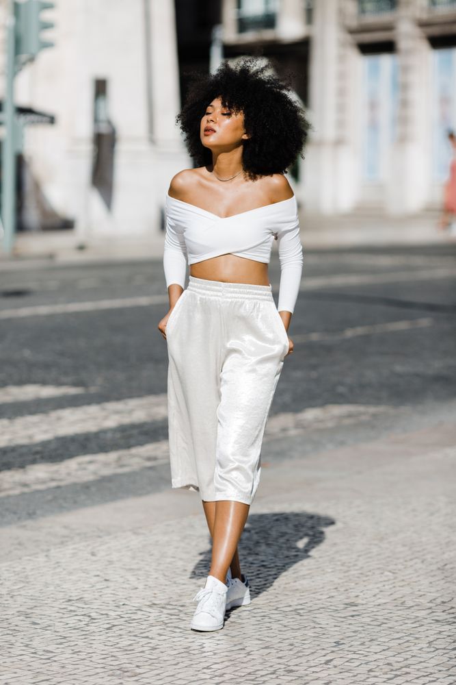 Young stylish female walking outdoors