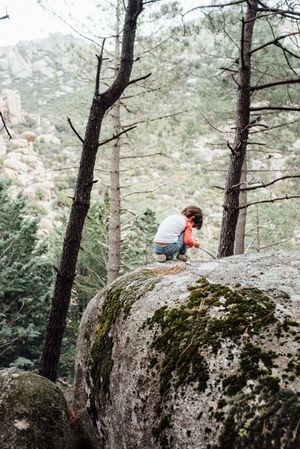 Boy walking on rocky hill