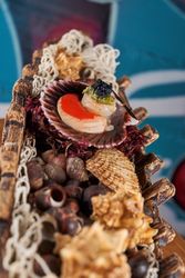 Tasty scallops on decorative boat