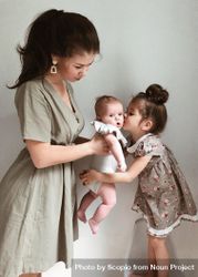 Mother and daughter holding a baby 0yd7Rb