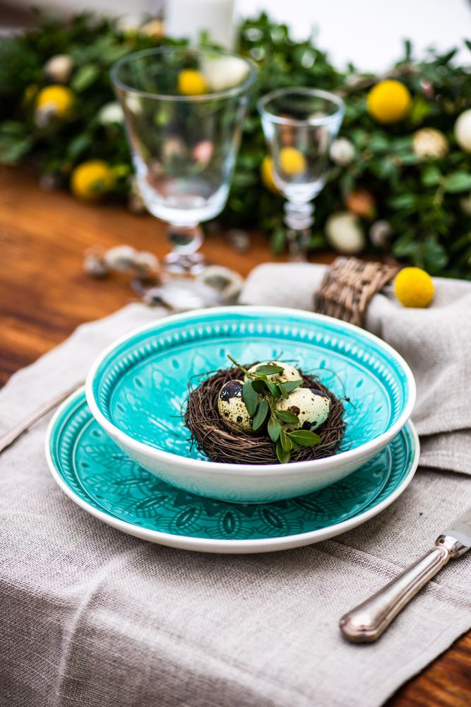 Easter table setting with teal bowl with bird nest