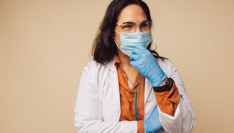 Female doctor wearing protective gloves and a protective mask