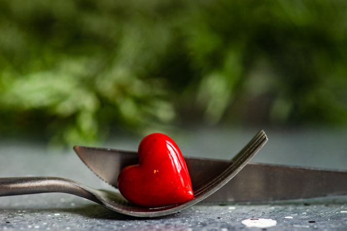 Fork and knife with bright red heart ornament