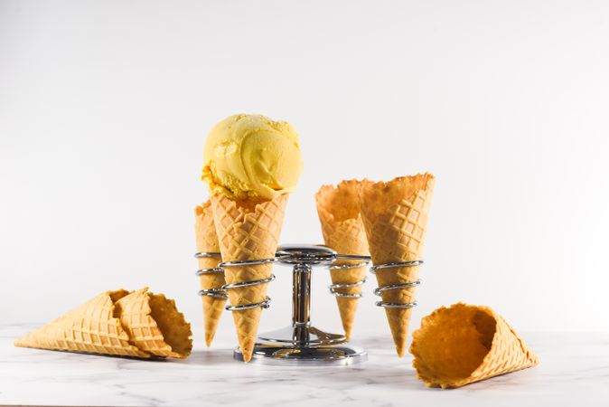 Ice cream cone stand with waffle cones and one scoop