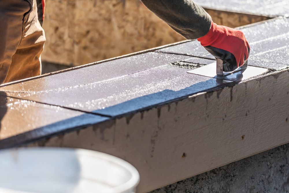 Construction Worker Using Stainless Steel Edger On Wet Cement Forming Coping Around New Pool