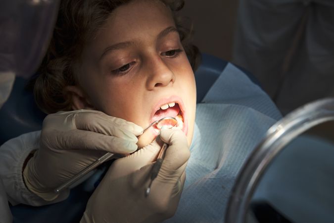 Boy undergoing dental treatment in clinic