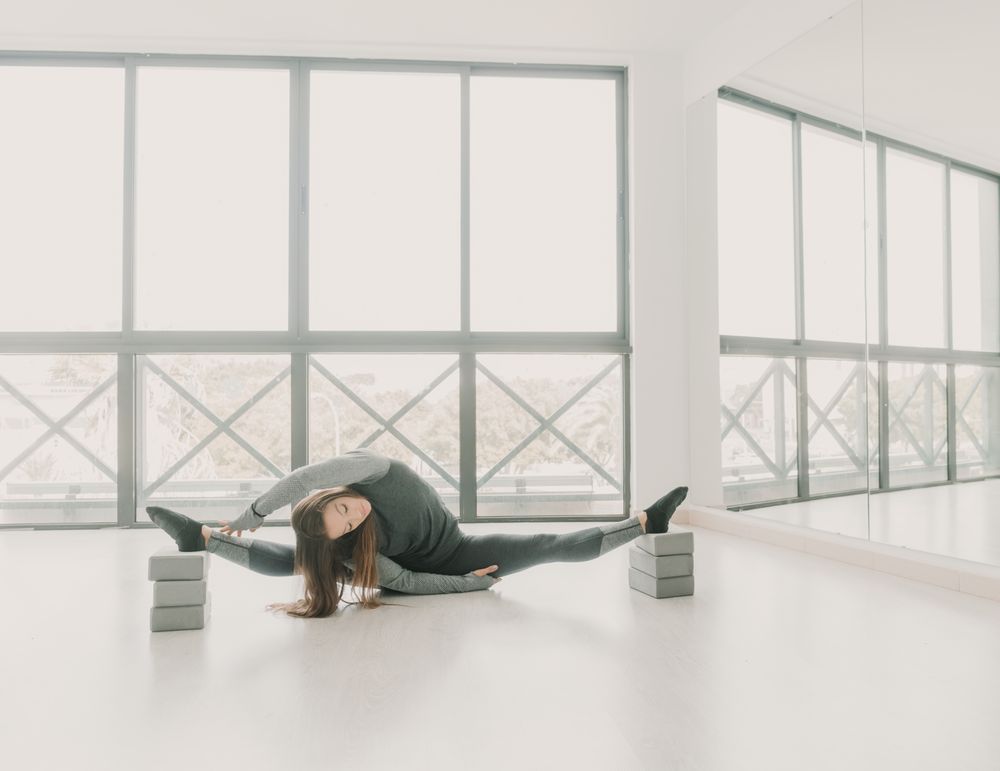 Flexible woman stretching in studio