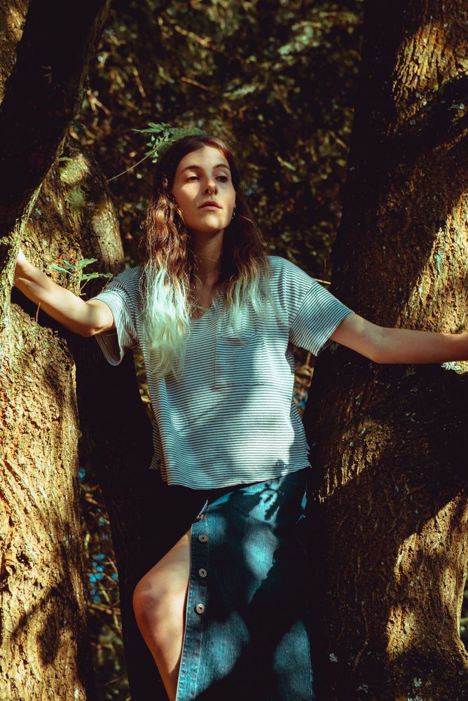 young woman near tree