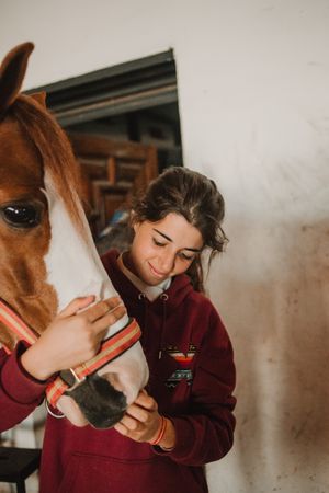 Girl with adorable pony in hat