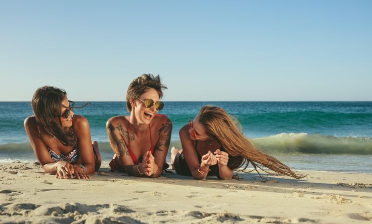 Cheerful group of friends enjoying beach day on a sunny day