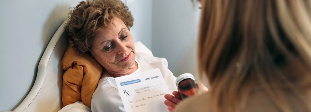 Doctor giving a prescription to mature patient
