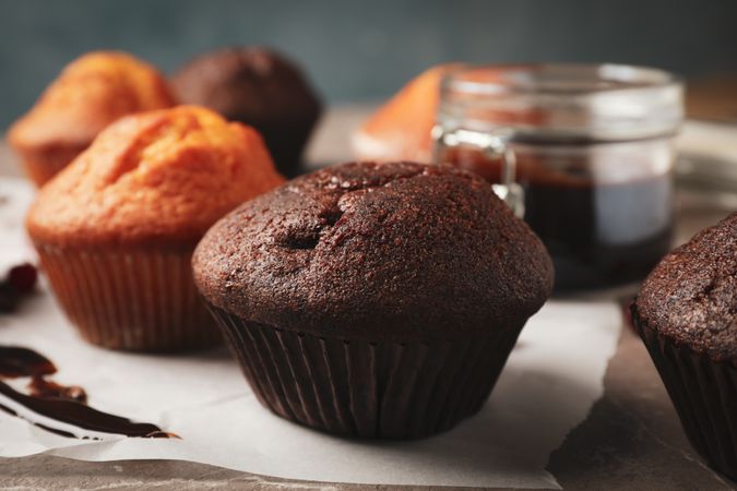 Composition with delicious muffins, berries, chocolate and baking paper