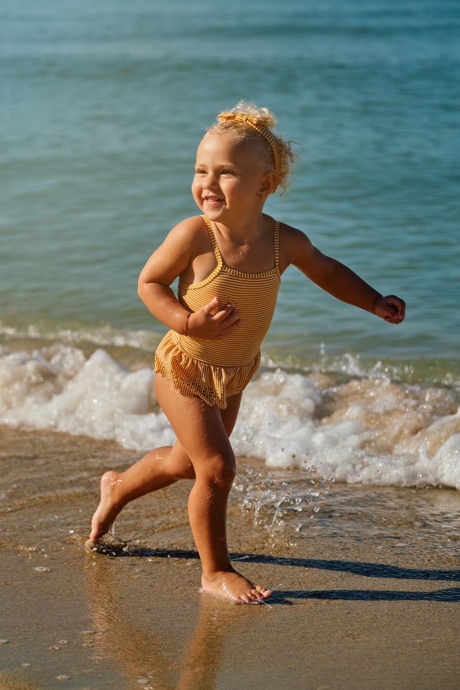 Happy girl running along seashore