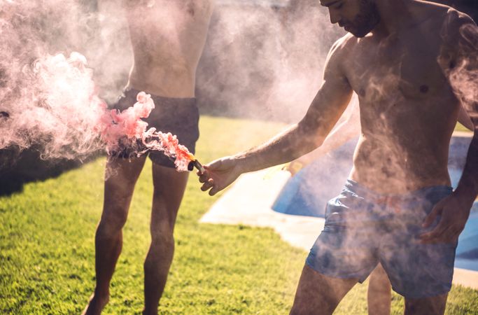 Friends lighting smoke torch