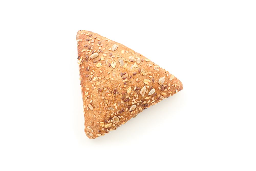 Triangular bun isolated on plain background, top view. Bakery products