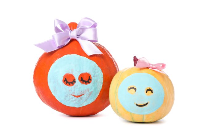Pumpkins with facial mask and bow