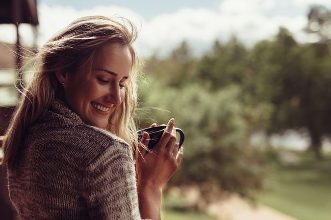 Beautiful woman smiling while having morning coffee