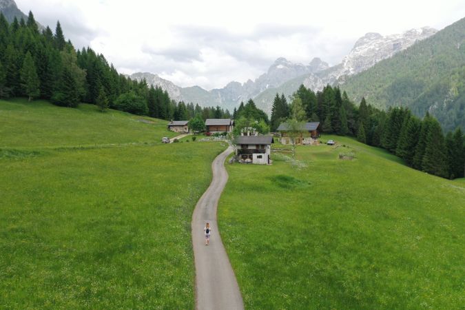 Person walking on pathway to a village in Raron, Switzerland