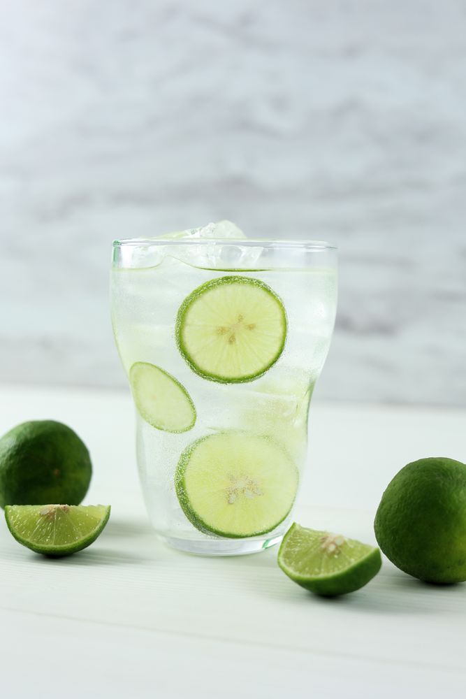 Mojito Cocktail in a Tall Clear Glass with Lime, Soda and Ice.