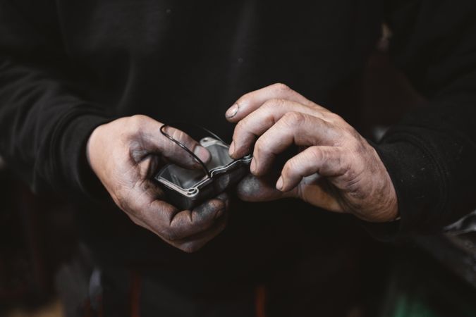 Crop man repairing detail