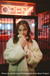 Attractive woman in fur coat standing outdoors at night 0Vq6Gb