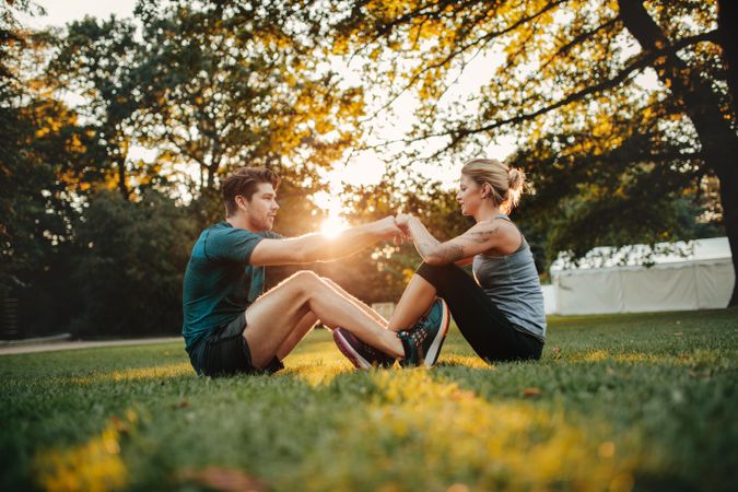 Man and woman sitting together holding hands and exercising