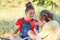 Laughing children having picnic in park