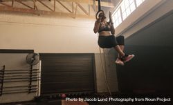 Woman doing workout on gymnastic rings 48B7mY