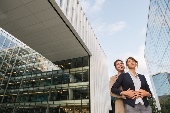 Businesspeople couple outside contemporary building