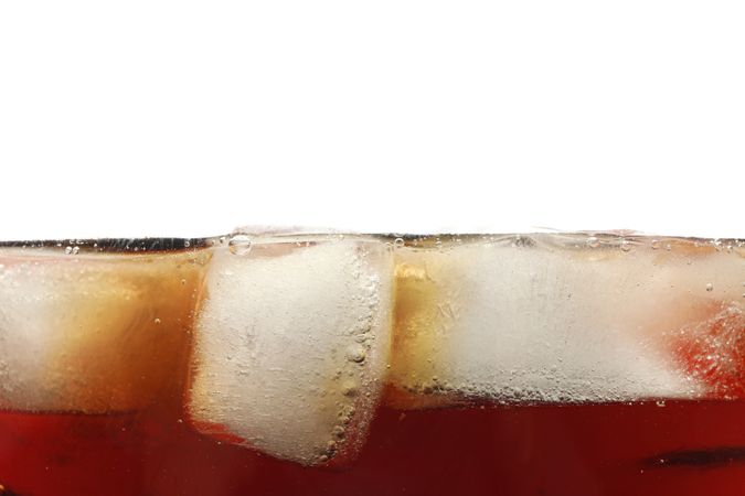 Side view background of cold cola with ice, isolated