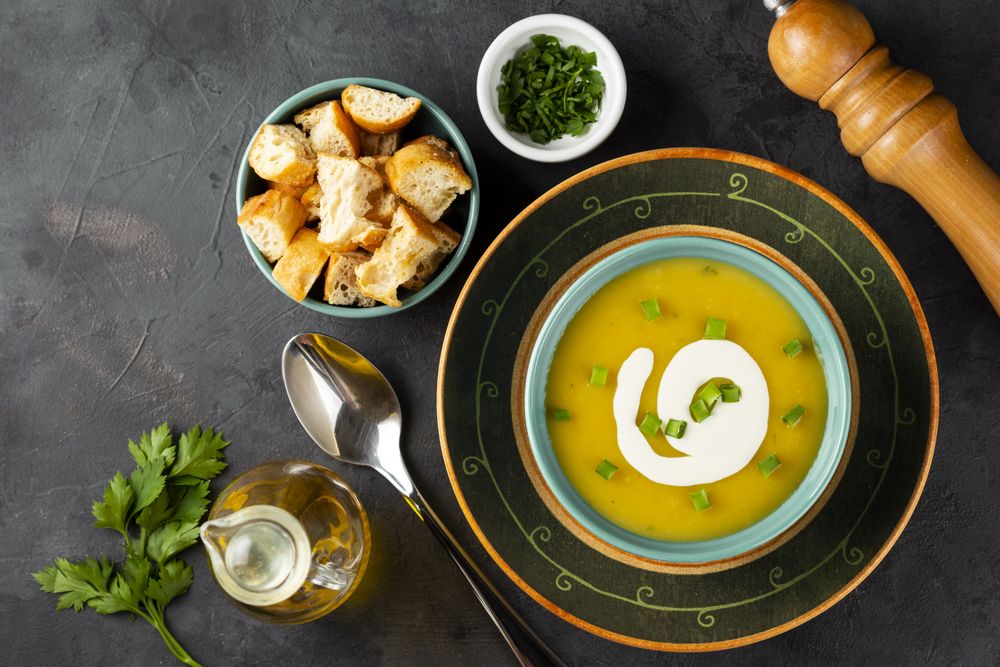 Bowl with pumpkin soup on the table.