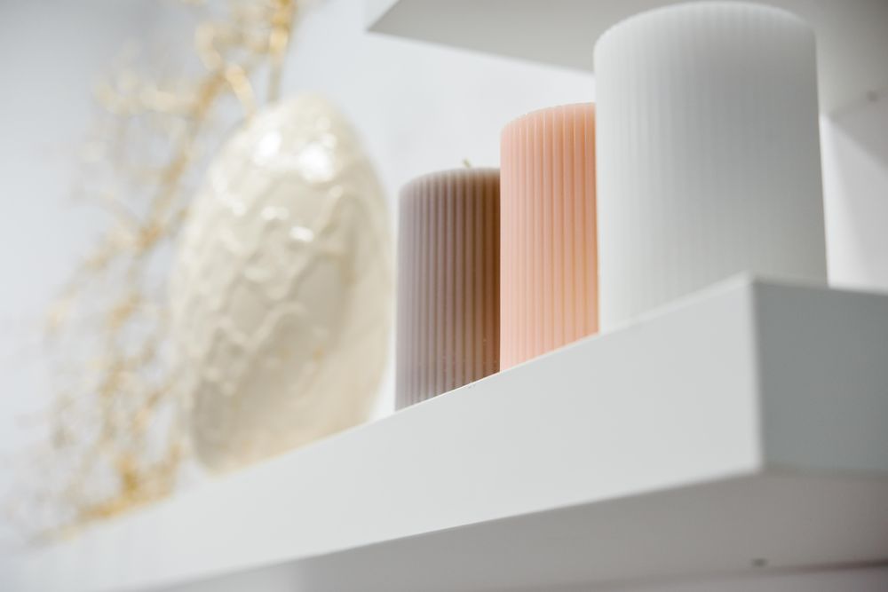 Shelf of decorative neutral candles