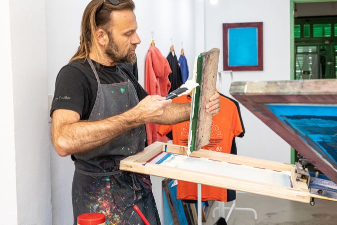 Artist printing screen in workshop