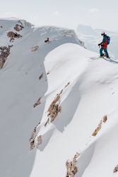 Man standing on top snow-capped mountain