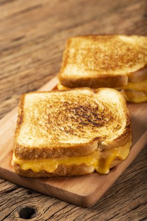 Grilled ham and cheese. Sandwich with cheese and ham on grill.