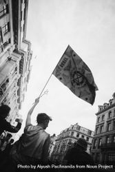 Monochrome shot of man carrying flag in Extinction Rebellion street protest in London 5Q2le4