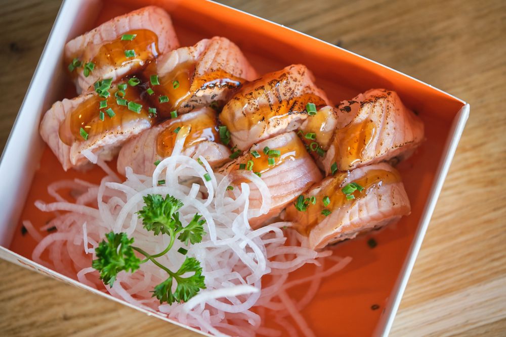 Seared salmon sushi rolls in box