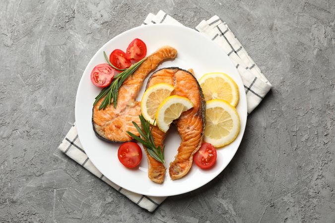 Composition with tasty grilled salmon on gray background, top view